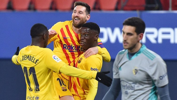 PAMPLONA, SPAIN - MARCH 06: Ilaix Moriba of FC Barcelona  celebrates with Lionel Messi and Ousmane Dembele  after scoring their teams second goal  during the La Liga Santander match between C.A. Osasuna and FC Barcelona at Estadio El Sadar on March 06, 2021 in Pamplona, Spain. Sporting stadiums around Spain remain under strict restrictions due to the Coronavirus Pandemic as Government social distancing laws prohibit fans inside venues resulting in games being played behind closed doors.  (Photo by Juan Manuel Serrano Arce/Getty Images)