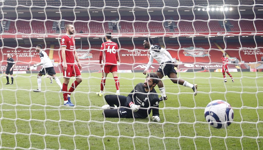 Liverpool's goalkeeper Alisson fails to save the goal from Fulham's Mario Lemina during the English Premier League soccer match between Liverpool and Fulham at Anfield stadium in Liverpool, England, Sunday, March 7, 2021. (Phil Noble/Pool via AP)
