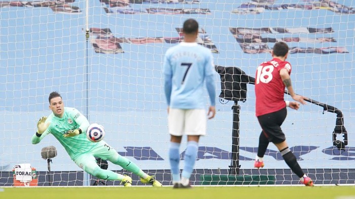 MANCHESTER, ENGLAND - MARCH 07: Bruno Fernandes of Manchester United scores their sides first goal past Ederson of Manchester City from the penalty spot during the Premier League match between Manchester City and Manchester United at Etihad Stadium on March 07, 2021 in Manchester, England. Sporting stadiums around the UK remain under strict restrictions due to the Coronavirus Pandemic as Government social distancing laws prohibit fans inside venues resulting in games being played behind closed doors. (Photo by Dave Thompson - Pool/Getty Images)