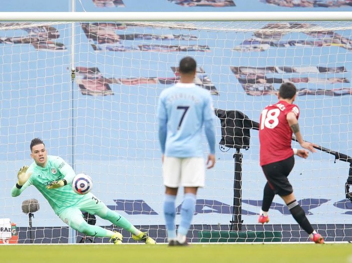 MANCHESTER, ENGLAND - MARCH 07: Bruno Fernandes of Manchester United scores their sides first goal past Ederson of Manchester City from the penalty spot during the Premier League match between Manchester City and Manchester United at Etihad Stadium on March 07, 2021 in Manchester, England. Sporting stadiums around the UK remain under strict restrictions due to the Coronavirus Pandemic as Government social distancing laws prohibit fans inside venues resulting in games being played behind closed doors. (Photo by Dave Thompson - Pool/Getty Images)