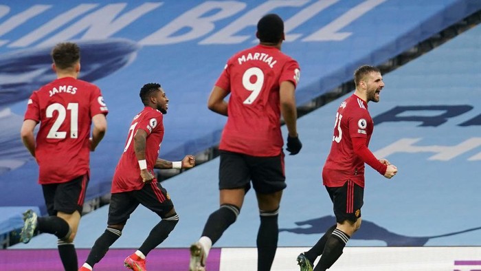 MANCHESTER, ENGLAND - MARCH 07: Luke Shaw of Manchester United celebrates after scoring their sides second goal during the Premier League match between Manchester City and Manchester United at Etihad Stadium on March 07, 2021 in Manchester, England. Sporting stadiums around the UK remain under strict restrictions due to the Coronavirus Pandemic as Government social distancing laws prohibit fans inside venues resulting in games being played behind closed doors. (Photo by Dave Thompson - Pool/Getty Images)
