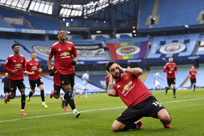 Manchester Uniteds Bruno Fernandes celebrates after scoring the opening goal during the English Premier League soccer match between Manchester City and Manchester United at the Etihad Stadium in Manchester, England, Sunday, March 7, 2021. (Laurence Griffiths/Pool via AP)