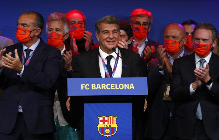 Joan Laporta, centre, celebrates his victory after elections at the Camp Nou stadium in Barcelona, Spain, Sunday, March 7, 2021. Joan Laporta has been elected Barcelonas president on Sunday, inheriting a club mired in debt and facing daunting problems that include the possible departure of Messi when his contract ends at the end of the season. (AP Photo/Joan Monfort)