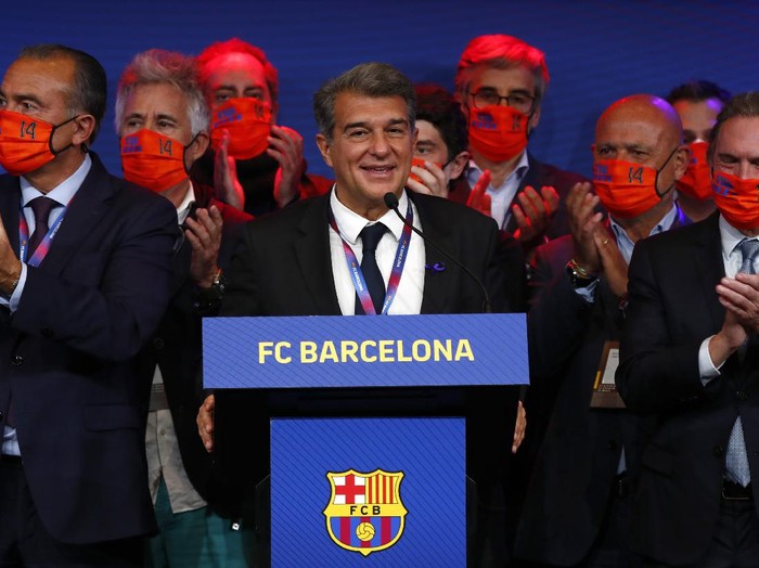 Joan Laporta, centre, celebrates his victory after elections at the Camp Nou stadium in Barcelona, Spain, Sunday, March 7, 2021. Joan Laporta has been elected Barcelona's president on Sunday, inheriting a club mired in debt and facing daunting problems that include the possible departure of Messi when his contract ends at the end of the season. (AP Photo/Joan Monfort)
