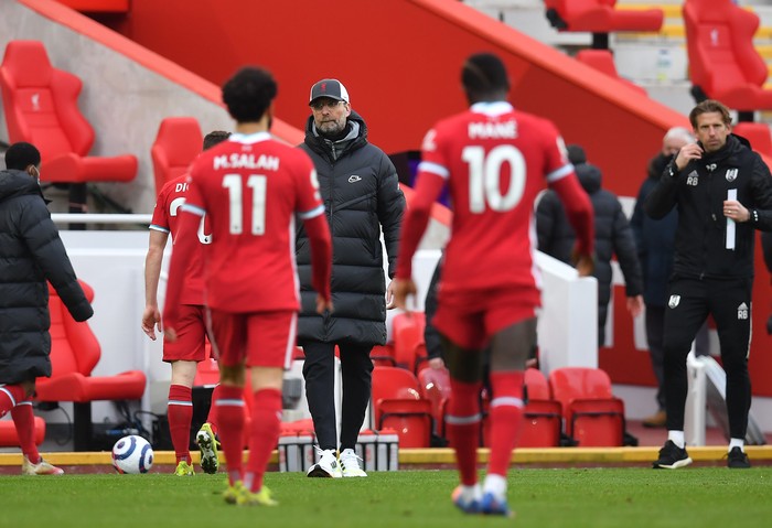 LIVERPOOL, ENGLAND - MARCH 07: Jurgen Klopp, Manager of Liverpool looks on as Mohamed Salah and Sadio Mane of Liverpool leave the pitch following the Premier League match between Liverpool and Fulham at Anfield on March 07, 2021 in Liverpool, England. Sporting stadiums around the UK remain under strict restrictions due to the Coronavirus Pandemic as Government social distancing laws prohibit fans inside venues resulting in games being played behind closed doors. (Photo by Paul Ellis - Pool/Getty Images)