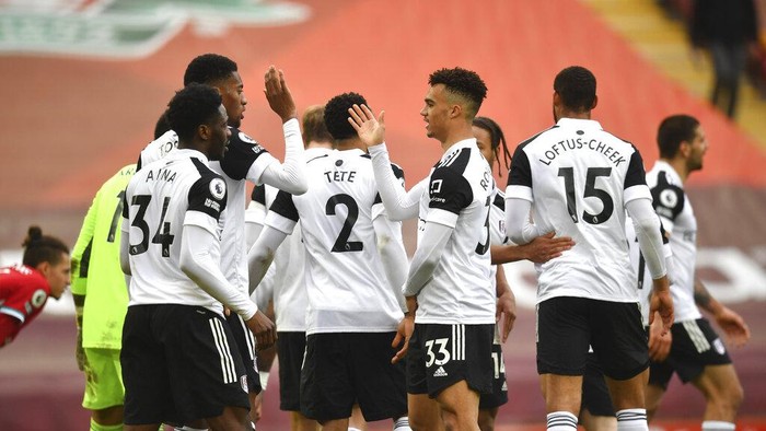 Fulham players celebrate at the end of the English Premier League soccer match between Liverpool and Fulham at Anfield stadium in Liverpool, England, Sunday, March 7, 2021. (Paul Ellis/Pool via AP)