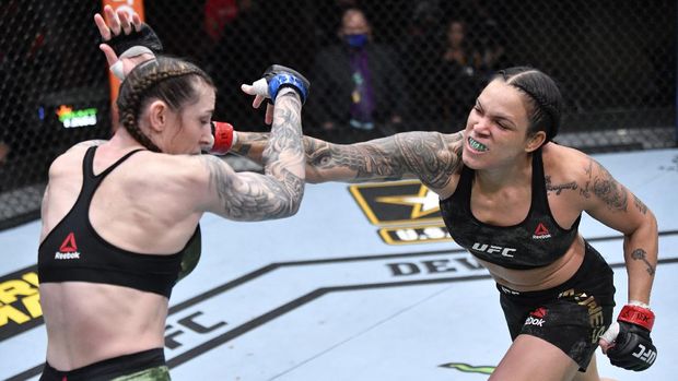 Mar 6, 2021; Las Vegas, NV, USA;  Amanda Nunes of Brazil punches Megan Anderson of Australia in their UFC featherweight championship fight during the UFC 259 event at UFC APEX on March 06, 2021 in Las Vegas, Nevada.  Mandatory Credit: Jeff Bottari/Handout Photo via USA TODAY Sports