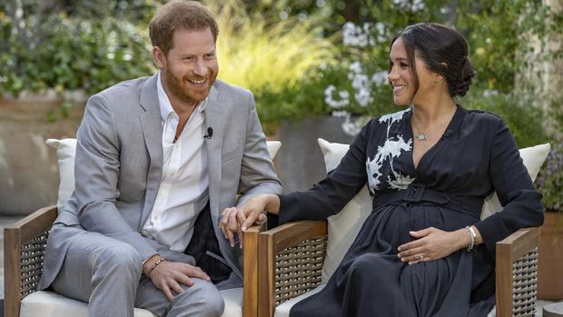 This image provided by Harpo Productions shows Prince Harry, left, and Meghan, Duchess of Sussex, speaking about expecting their second child during an interview with Oprah Winfrey. 