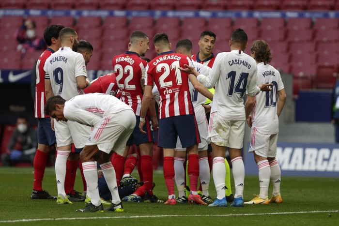 Players confront each other during the Spanish La Liga soccer match between Atletico Madrid and Real Madrid at the Wanda Metropolitano stadium in Madrid, Spain, Sunday, March 7, 2021. (AP Photo/Manu Fernandez)