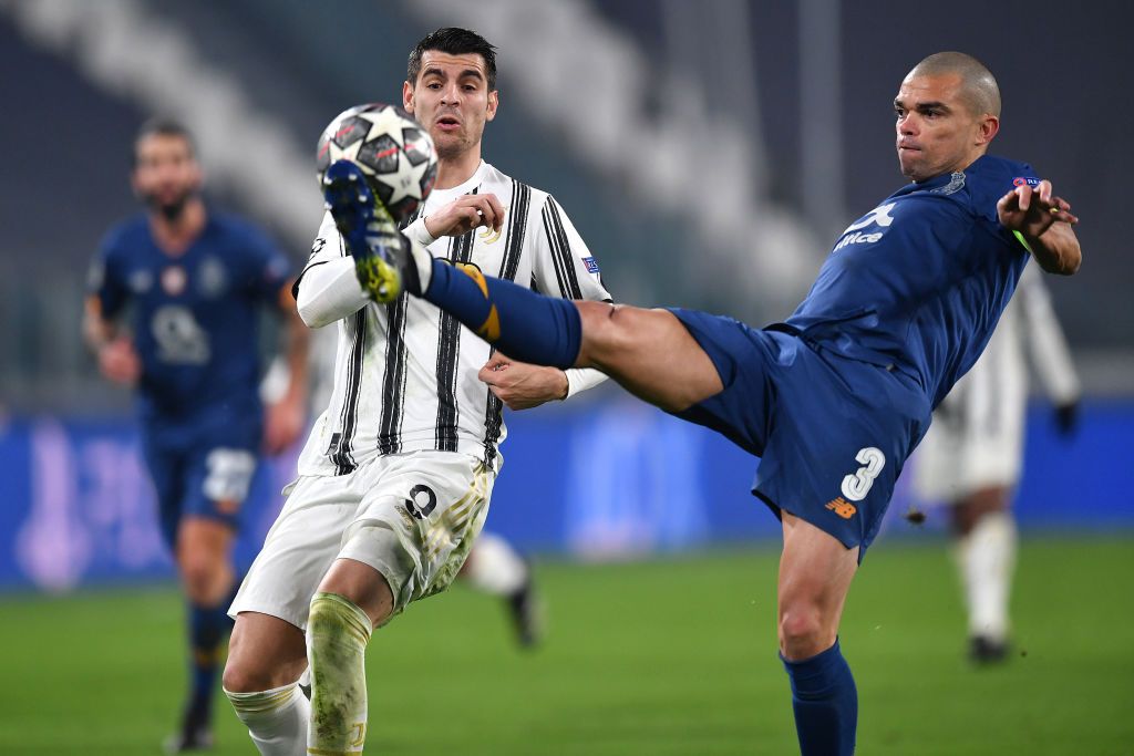 TURIN, ITALY - MARCH 09: Pepe of Porto attempts to clear the ball whilst under pressure from Alvaro Morata of Juventus during the UEFA Champions League Round of 16 match between Juventus and FC Porto at Juventus Arena on March 09, 2021 in Turin, Italy. Sporting stadiums around Italy remain under strict restrictions due to the Coronavirus Pandemic as Government social distancing laws prohibit fans inside venues resulting in games being played behind closed doors. (Photo by Valerio Pennicino/Getty Images)