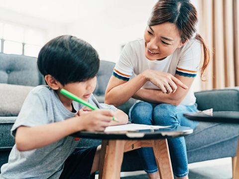 Young mother teaching her son