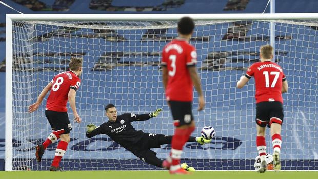 Britain Soccer Premier League Southampton's James Ward-Prowse shoots to score from the penalty spot during the English Premier League soccer match between Manchester City and Southampton at the Etihad Stadium in Manchester, England, Wednesday, March 10, 2021. (Clive Brunskill/Pool via AP)