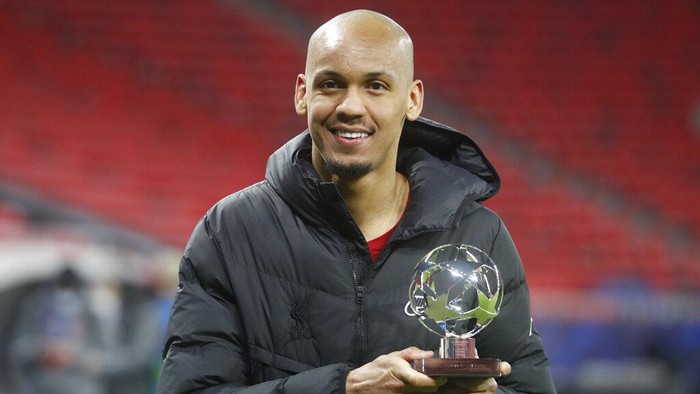 Liverpools Fabinho holds the player of the match trophy after the Champions League round of 16 second leg soccer match between Liverpool and RB Leipzig at the Puskas Arena stadium in Budapest, Hungary, Wednesday, March 10, 2021. (AP Photo/Laszlo Balogh)