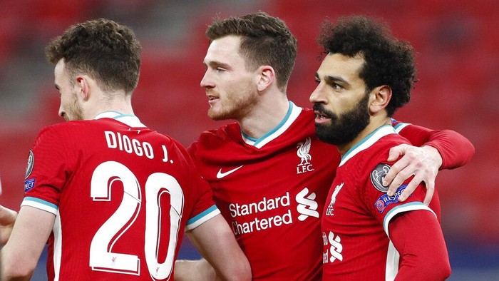 Liverpools Mohamed Salah, right, celebrates after scoring his sides opening goal during the Champions League round of 16 second leg soccer match between Liverpool and RB Leipzig at the Puskas Arena stadium in Budapest, Hungary, Wednesday, March 10, 2021. (AP Photo/Laszlo Balogh)