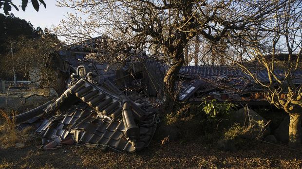 A collapsed building at a Buddhist temple lies in Futaba town, Fukushima prefecture, northeastern Japan, Sunday, Feb. 28, 2021. The temple is in the area that used to be designated as the nuclear disaster exclusion zone, but the part of the zone has been lifted since March 2020. (AP Photo/Hiro Komae)