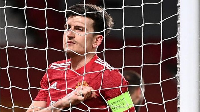 MANCHESTER, ENGLAND - MARCH 11: Harry Maguire of Manchester United reacts after a missed chance during the UEFA Europa League Round of 16 First Leg match between Manchester United and A.C. Milan at Old Trafford on March 11, 2021 in Manchester, England. Sporting stadiums around the UK remain under strict restrictions due to the Coronavirus Pandemic as Government social distancing laws prohibit fans inside venues resulting in games being played behind closed doors. (Photo by Laurence Griffiths/Getty Images)