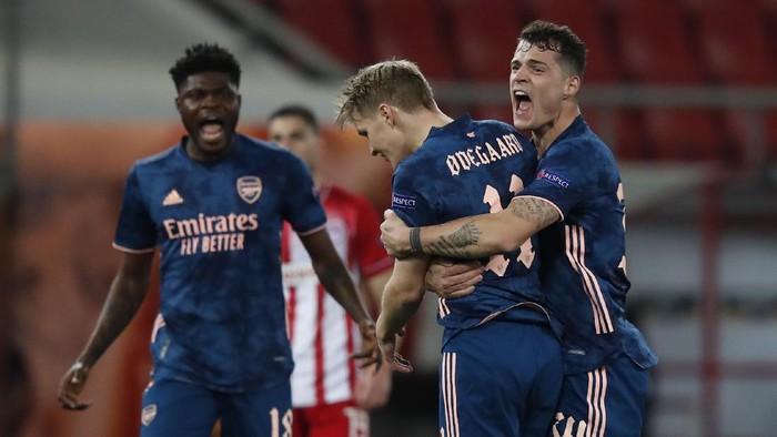 Arsenals Martin Odegaard, centre celebrates with teammates after scoring the opening goal during the Europa League round of 16, first leg, soccer match between Olympiacos and Arsenal at Georgios Karaiskakis stadium, in Piraeus port, near Athens, Thursday, March 11, 2021. (AP Photo/Thanassis Stavrakis)