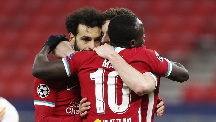 Liverpools Mohamed Salah, left, celebrates after scoring his sides opening goal during the Champions League round of 16 second leg soccer match between Liverpool and RB Leipzig at the Puskas Arena stadium in Budapest, Hungary, Wednesday, March 10, 2021. (AP Photo/Laszlo Balogh)