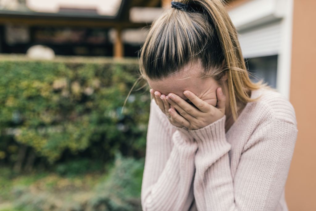 Close-up portrait of a girl crying and covering her face. Lonely woman in despair. upset. Depress woman outdoor Woman Suffering From Depression. Negative human emotion face expression. Stress. A woman cry