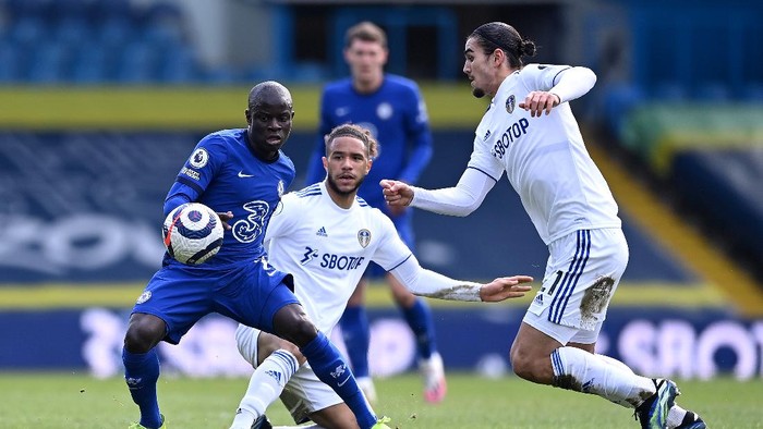 LEEDS, ENGLAND - MARCH 13: Ngolo Kante of Chelsea battles for possession with Tyler Roberts and Pascal Struijk of Leeds United during the Premier League match between Leeds United and Chelsea at Elland Road on March 13, 2021 in Leeds, England. Sporting stadiums around the UK remain under strict restrictions due to the Coronavirus Pandemic as Government social distancing laws prohibit fans inside venues resulting in games being played behind closed doors. (Photo by Laurence Griffiths/Getty Images)