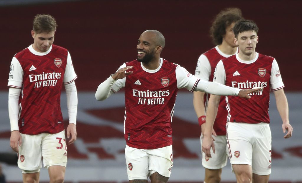 Alexandre Lacazette, Arsenal center, celebrates after scoring his team's second goal during the English Premier League soccer match between Arsenal and Tottenham Hotspur at the Emirates Stadium in London, England on Sunday March 14, 2021 (Nick Potts / Pool via AP).