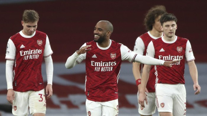 Arsenals Alexandre Lacazette, centre, celebrates after scoring his sides second goal during the English Premier League soccer match between Arsenal and Tottenham Hotspur at the Emirates stadium in London, England, Sunday, March 14, 2021. (Nick Potts/Pool via AP)