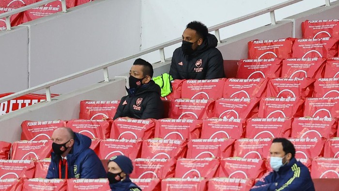 LONDON, ENGLAND - MARCH 14: Pierre Emerick Aubameyang of Arsenal looks on from the substitutes stand during the Premier League match between Arsenal and Tottenham Hotspur at Emirates Stadium on March 14, 2021 in London, England. Sporting stadiums around the UK remain under strict restrictions due to the Coronavirus Pandemic as Government social distancing laws prohibit fans inside venues resulting in games being played behind closed doors. (Photo by Julian Finney/Getty Images)