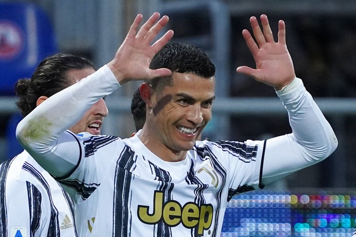 Juventus Cristiano Ronaldo celebrates after scoring his sides third goal for his personal hat trick in thirty minutes during the Italian Serie A soccer match between Cagliari and Juventus, at the Sardegna Arena stadium in Cagliari, Italy, Sunday, March 14, 2021. (Alessandro Tocco/LaPresse via AP)