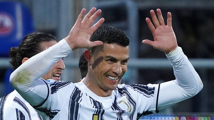 Juventus Cristiano Ronaldo celebrates after scoring his sides third goal for his personal hat trick in thirty minutes during the Italian Serie A soccer match between Cagliari and Juventus, at the Sardegna Arena stadium in Cagliari, Italy, Sunday, March 14, 2021. (Alessandro Tocco/LaPresse via AP)