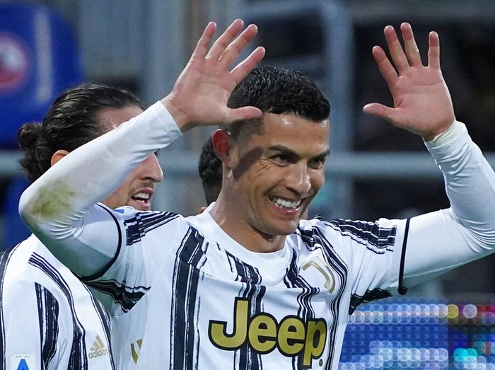 Juventus' Cristiano Ronaldo celebrates after scoring his side's third goal for his personal hat trick in thirty minutes during the Italian Serie A soccer match between Cagliari and Juventus, at the Sardegna Arena stadium in Cagliari, Italy, Sunday, March 14, 2021. (Alessandro Tocco/LaPresse via AP)