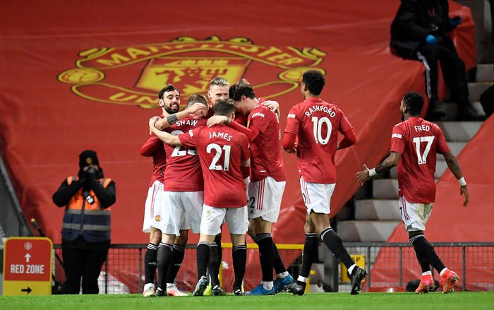 Manchester United MANCHESTER, ENGLAND - MARCH 14: Scott McTominay of Manchester United celebrates with Bruno Fernandes and team mates after their side's first goal, an own goal scored by Craig Dawson (Not pictured) of West Ham United during the Premier League match between Manchester United and West Ham United at Old Trafford on March 14, 2021 in Manchester, England. Sporting stadiums around the UK remain under strict restrictions due to the Coronavirus Pandemic as Government social distancing laws prohibit fans inside venues resulting in games being played behind closed doors. (Photo by Peter Powell - Pool/Getty Images)