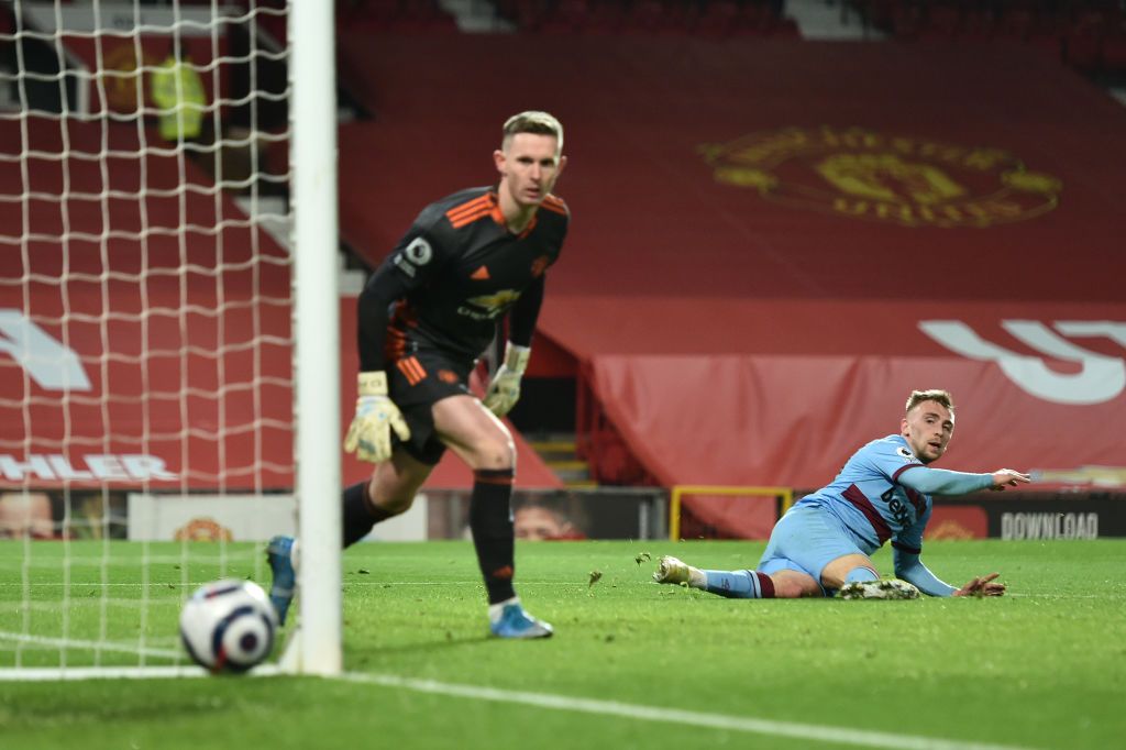 MANCHESTER, ENGLAND - MARCH 14: Dean Henderson of Manchester United punches the ball away as he collides with team mate Harry Maguire and Jarrod Bowen of West Ham United during the Premier League match between Manchester United and West Ham United at Old Trafford on March 14, 2021 in Manchester, England. Sporting stadiums around the UK remain under strict restrictions due to the Coronavirus Pandemic as Government social distancing laws prohibit fans inside venues resulting in games being played behind closed doors. (Photo by Clive Brunskill/Getty Images)