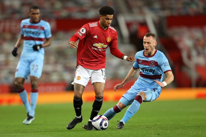MANCHESTER, ENGLAND - MARCH 14: Marcus Rashford of Manchester United is challenged by Vladimir Coufal of West Ham United during the Premier League match between Manchester United and West Ham United at Old Trafford on March 14, 2021 in Manchester, England. Sporting stadiums around the UK remain under strict restrictions due to the Coronavirus Pandemic as Government social distancing laws prohibit fans inside venues resulting in games being played behind closed doors. (Photo by Clive Brunskill/Getty Images)