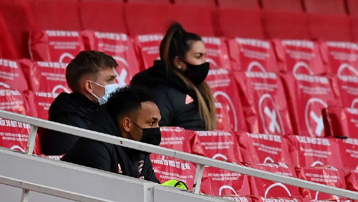 LONDON, ENGLAND - MARCH 14: Pierre Emerick Aubameyang of Arsenal looks on from the substitutes stand during the Premier League match between Arsenal and Tottenham Hotspur at Emirates Stadium on March 14, 2021 in London, England. Sporting stadiums around the UK remain under strict restrictions due to the Coronavirus Pandemic as Government social distancing laws prohibit fans inside venues resulting in games being played behind closed doors. (Photo by Dan Mullan/Getty Images)