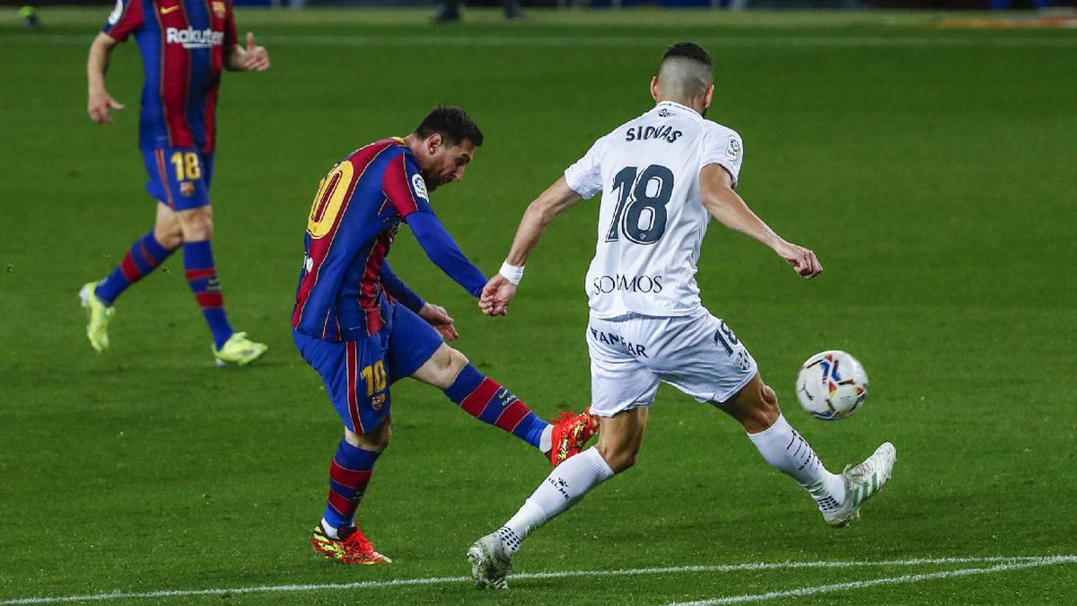 Aksi penyerang Barcelona, Lionel Messi (kiri), saat membobol gawang Hueca. (Foto: Joan Monfort/AP)