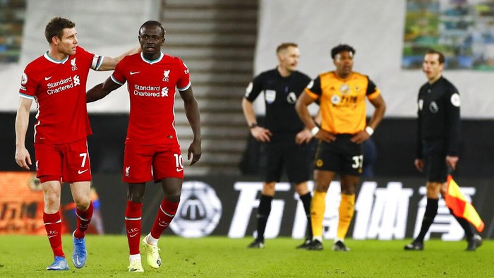 Liverpools James Milner, left, and teammate Sadio Mane react following the English Premier League soccer match between Wolverhampton Wanderers and Liverpool at Molineux Stadium in Wolverhampton, England, Monday, March. 15, 2021. (AP Photo/Jason Cairnduff,Pool)