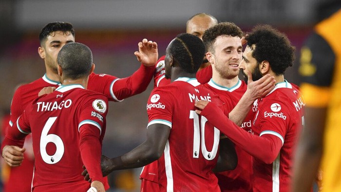 Liverpools Diogo Jota, second right, celebrates with teammate Mohamed Salah, right, after scoring his teams first goal during the English Premier League soccer match between Wolverhampton Wanderers and Liverpool at Molineux Stadium in Wolverhampton, England, Monday, March. 15, 2021. (AP Photo/Paul Ellis,Pool)