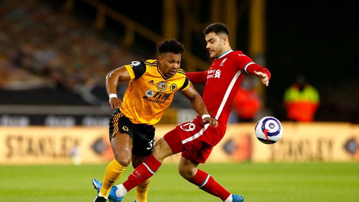 WOLVERHAMPTON, ENGLAND - MARCH 15: Adama Traore of Wolverhampton Wanderers is challenged by Ozan Kabak of Liverpool during the Premier League match between Wolverhampton Wanderers and Liverpool at Molineux on March 15, 2021 in Wolverhampton, England. Sporting stadiums around the UK remain under strict restrictions due to the Coronavirus Pandemic as Government social distancing laws prohibit fans inside venues resulting in games being played behind closed doors. (Photo by Jason Cairnduff - Pool/Getty Images)
