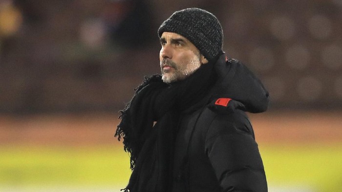 Manchester Citys head coach Pep Guardiola walks on the pitch before an English Premier League soccer match between Fulham and Manchester City at the Craven Cottage stadium in London, England, Saturday March 13, 2021. (Adam Davy/Pool via AP)