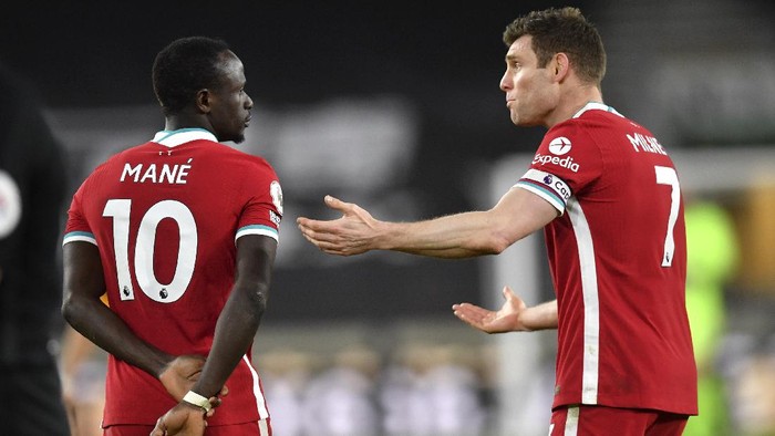 Liverpools James Milner, right, gestures to teammate Sadio Mane during the English Premier League soccer match between Wolverhampton Wanderers and Liverpool at Molineux Stadium in Wolverhampton, England, Monday, March. 15, 2021. (AP Photo/Paul Ellis,Pool)