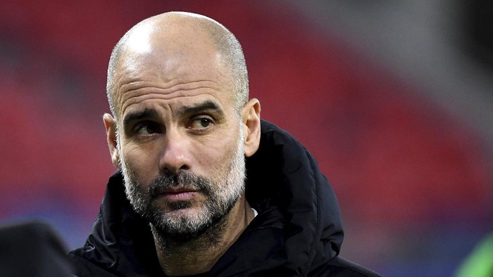 Manchester Citys head coach Pep Guardiola reacts after a Champions League round of 16 second leg soccer match between Manchester City and Borussia Moenchengladbach at the Puskas Arena in Budapest, Hungary, Tuesday, March 16, 2021. (Tibor Illyes/MTI via AP)
