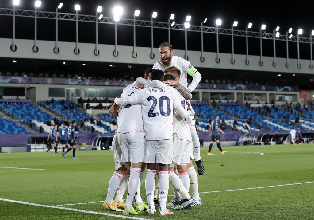 MADRID, SPAIN - MARCH 16: Karim Benzema of Real Madrid celebrates with Sergio Ramos and team mates after scoring their side's first goal during the UEFA Champions League Round of 16 match between Real Madrid and Atalanta at Estadio Alfredo Di Stefano on March 16, 2021 in Madrid, Spain. Sporting stadiums around Spain remain under strict restrictions due to the Coronavirus Pandemic as Government social distancing laws prohibit fans inside venues resulting in games being played behind closed doors. (Photo by Gonzalo Arroyo Moreno/Getty Images)