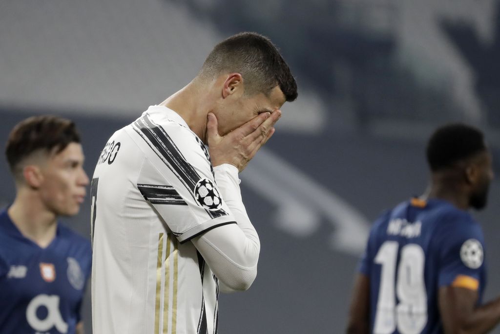FILE - In this Tuesday, March 9, 2021 file photo Juventus' Cristiano Ronaldo reacts during the Champions League, round of 16, second leg, soccer match between Juventus and Porto in Turin, Italy. Neither Lionel Messi nor Cristiano Ronaldo will be in the Champions League quarterfinals for the first time since 2005. The two greatest players of the current generation were both eliminated from the competition this week. Messi scored a goal but missed a penalty as Barcelona was eliminated by Paris Saint-Germain. Ronaldo and his Juventus teammates were ousted by Porto the night before. Ronaldo has won five Champions League titles in his career. Messi has won four. (AP Photo/Luca Bruno, File)