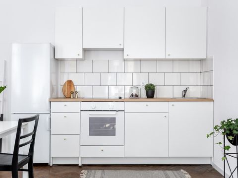 Ilustrasi Dapur Minimalis Contemporary kitchen with white cupboards and dining table with black chairs