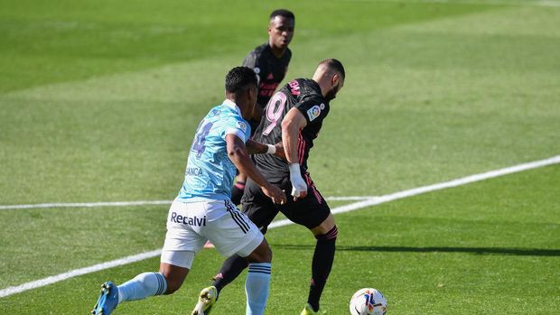 VIGO, SPAIN - MARCH 20: Karim Benzema of Real Madrid scores his team's second goal during the La Liga Santander match between RC Celta and Real Madrid at Abanca-Balaidos on March 20, 2021 in Vigo, Spain.  Sports stadiums in Spain remain under strict restrictions due to the coronavirus pandemic, as the government's social distancing laws prohibit fans from entering venues, causing matches to be played behind closed doors.  (Photo by Octavio Passos / Getty Images)