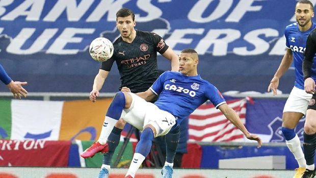 Manchester City's Ruben Dias, left, and Everton's Richarlison challenge for the ball during the English FA Cup sixth round soccer match between Everton and Manchester City at Goodison Park in Liverpool, England, Saturday, March 20, 2021. (AP Photo/Jon Super, Pool)