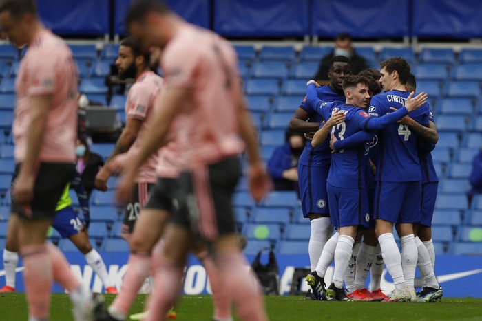 Chelseas Olivier Giroud, center, is challenged by Sheffield Uniteds Phil Jagielka, right, during the English FA Cup quarterfinal soccer match between Chelsea and Sheffield United at the Stamford Bridge stadium in London, Sunday, March 21, 2021. (AP Photo/Kirsty Wigglesworth)