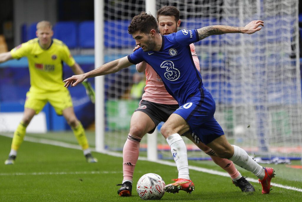 Chelsea's Christian Pulisic is challenged by Sheffield United's Oliver Norwood, rear, during the English FA Cup quarterfinal soccer match between Chelsea and Sheffield United at the Stamford Bridge stadium in London, Sunday, March 21, 2021. (AP Photo/Kirsty Wigglesworth)