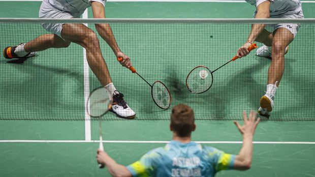 France's Christo Popov (L) and France's Toma Junior Popov (R) play a shot against Denmark's Kim Astrup and Denmark's Anders Skaarup Rasmussen during the men's doubles quarter-final match on day three of the All England Open Badminton Championship, at the Utilita Arena in Birming ham, central England, on March 19, 2021. (Photo by Adrian DENNIS / AFP)