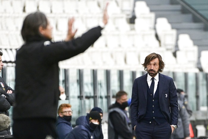 Juventus coach Andrea Pirlo, right, looks at Benevento coach Filippo Inzaghi during a Serie A soccer match between Juventus and Benevento at the Allianz stadium in Turin, Italy, Sunday, March 21, 2021. Juventus lost 0-1. (Marco Alpozzi/LaPresse via AP)